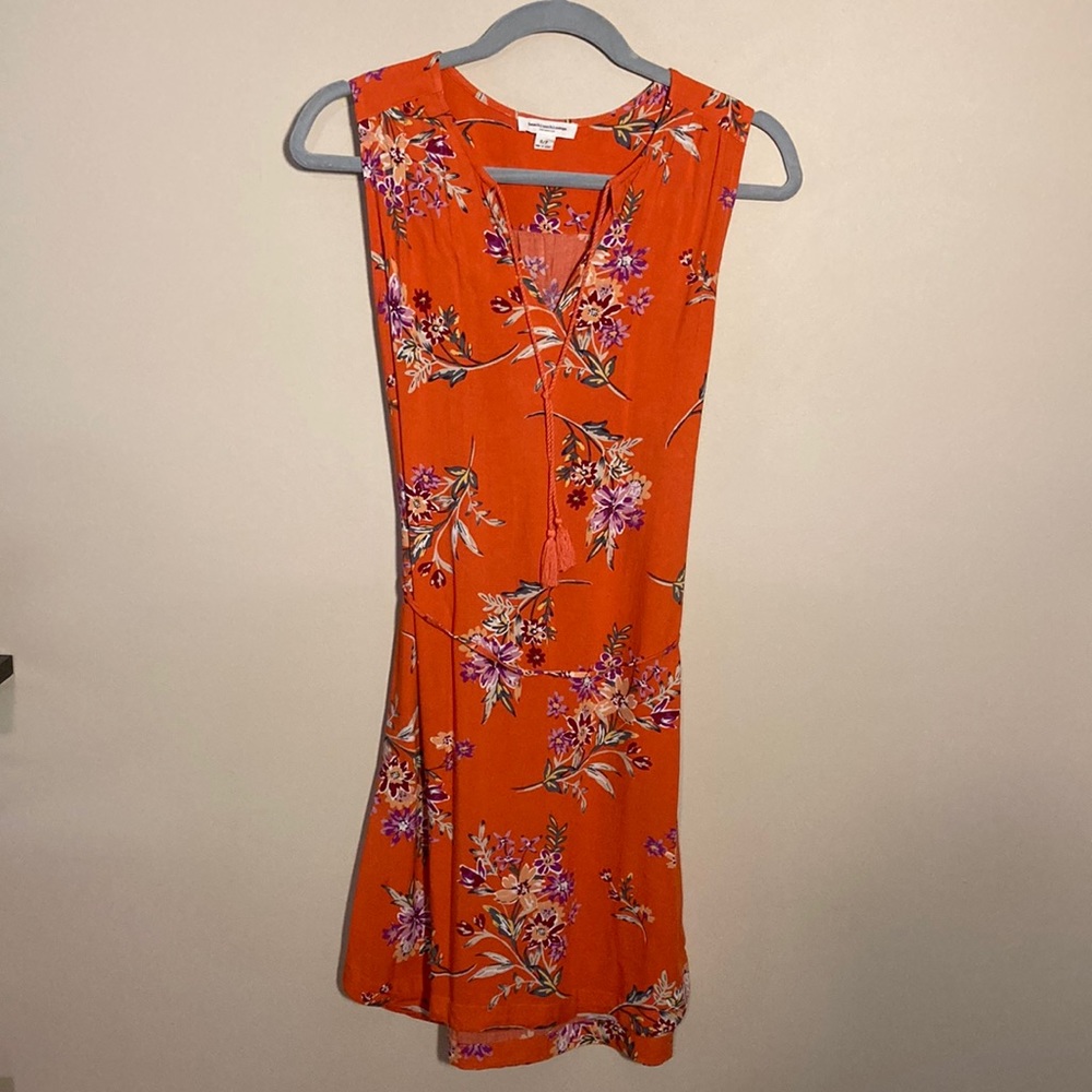 Women’s size small sleeveless dress. Orange with floral patterns.